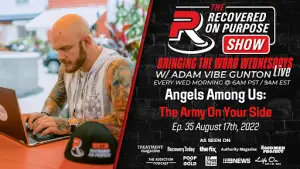 Bald man with tattoos works on a laptop outdoors. Text promotes "The Recovered On Purpose Show," episode details, and media features. Vibrant, focused tone.