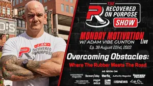 Man with tattoos and crossed arms stands confidently beside text promoting "Recovered On Purpose Show" with Adam Vibe Gunton, airing August 22, 2022.
