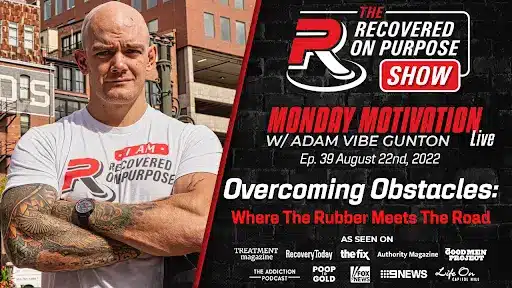Man with tattoos and crossed arms stands confidently beside text promoting "Recovered On Purpose Show" with Adam Vibe Gunton, airing August 22, 2022.