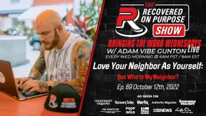 Bald man with a beard types on a laptop outdoors beside a branded microphone and mug. Text promotes "The Recovered On Purpose Show," airing October 12, 2022.