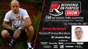 Image of a promotional poster for "The Recovered On Purpose Show" with Adam Vibe Gunton. A bald man with tattoos crouches on the left, wearing a show T-shirt. The show's details are listed on a black and red-themed design, with guest Jonathon Wasp. The poster features logos of media outlets showcasing the show.