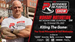 A bald man with tattoos and muscular build crosses his arms confidently. Text beside him promotes "The Recovered On Purpose Show" with a motivational theme.