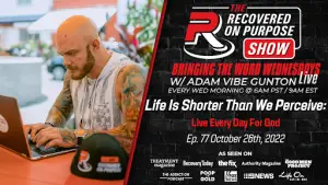 A man with tattoos is focused on a laptop in a casual outdoor setting. Text promotes "The Recovered On Purpose Show" with details for a live event.