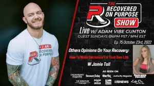 A smiling man with tattoos and a "Recovered On Purpose" shirt stands against a dark background. Text details a live show with Adam Vibe Gunton featuring Jamie Tall, airing October 23, 2022, about making life decisions. Logos of media outlets are displayed at the bottom.